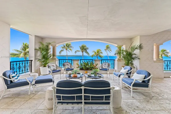a outdoor living space with furniture a rug and a potted plant