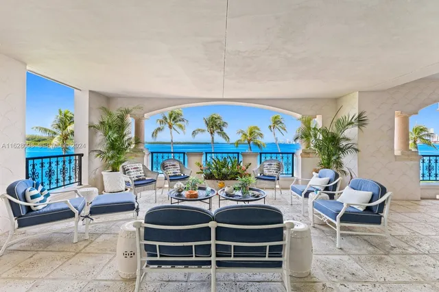 a outdoor living space with furniture a rug and a potted plant