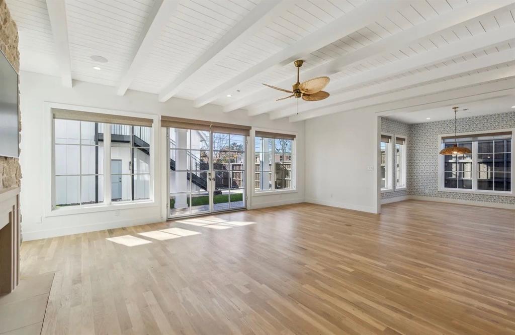 5800 Goodwin Avenue Dallas, TX 75206 - Photo 13 of 39 This spacious room features light-toned hardwood floors and a white beamed ceiling, complemented by several large windows providing ample natural light