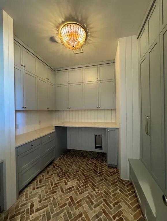 5800 Goodwin Avenue Dallas, TX 75206 - Photo 17 of 39 This functional space features extensive cabinetry, herringbone brick flooring, and a decorative ceiling light fixture