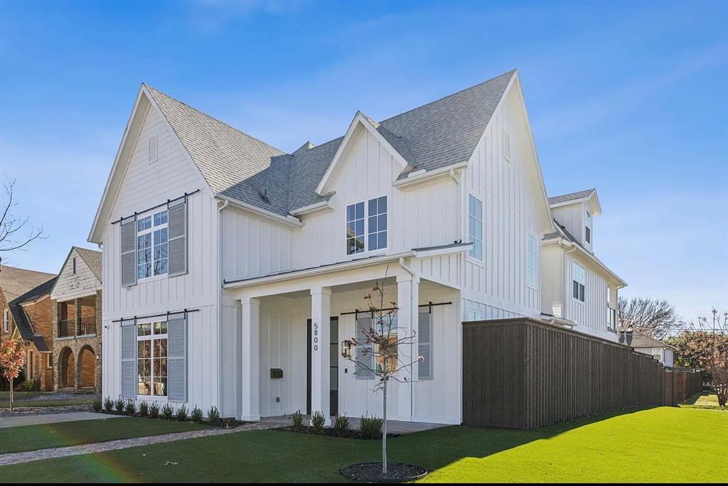 5800 Goodwin Avenue Dallas, TX 75206 - Photo 2 of 39 The property features a white exterior with vertical siding, grey roof shingles, and a front porch supported by columns
