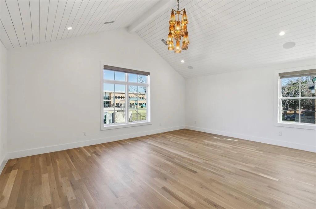 5800 Goodwin Avenue Dallas, TX 75206 - Photo 25 of 39 This bright room features a vaulted ceiling with shiplap detailing, recessed lighting, and a decorative chandelier