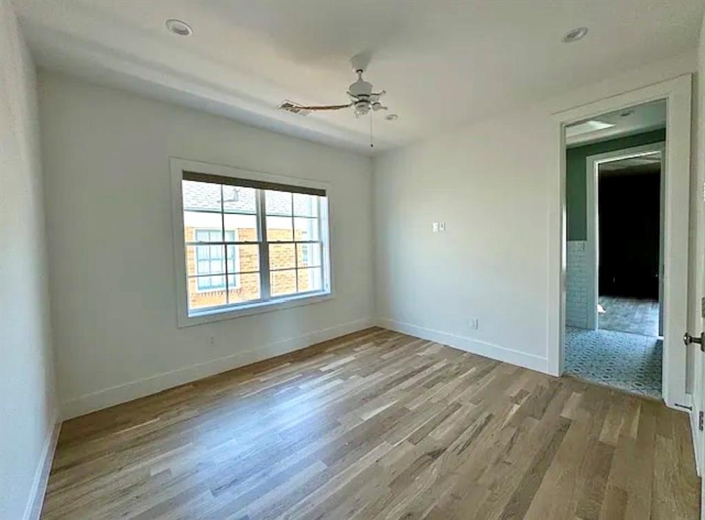 5800 Goodwin Avenue Dallas, TX 75206 - Photo 33 of 39 This room features light wood-look flooring, a window with blinds, and a ceiling fan with integrated lighting