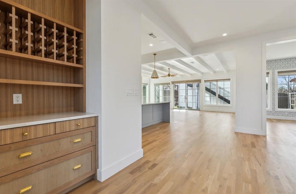 5800 Goodwin Avenue Dallas, TX 75206 - Photo 6 of 39 This open-concept interior features hardwood floors and white walls, creating a bright and spacious atmosphere