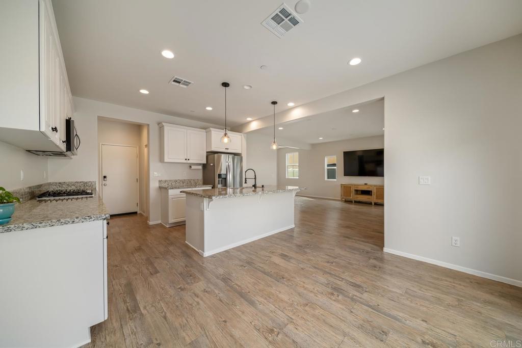 352 Misaki Way Fallbrook, CA 92028 - Photo 15 of 68 a large kitchen with kitchen island a stove a sink a refrigerator and a counter top space