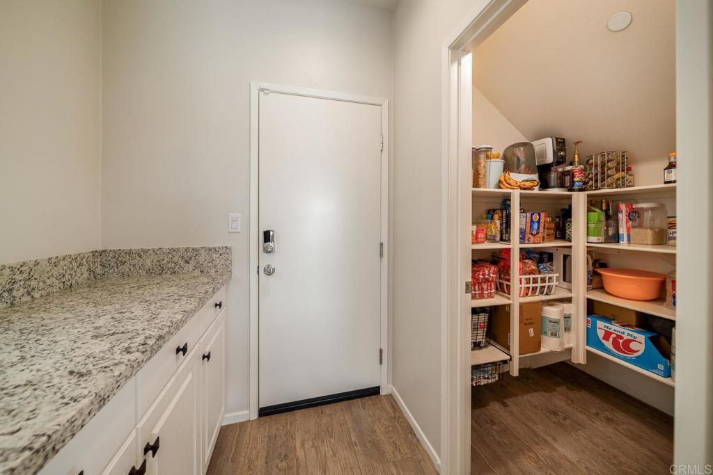 352 Misaki Way Fallbrook, CA 92028 - Photo 18 of 68 a view of a kitchen with fridge and wooden floor