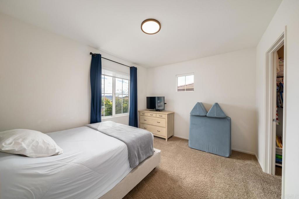 352 Misaki Way Fallbrook, CA 92028 - Photo 35 of 68 a bedroom with a bed and a large window