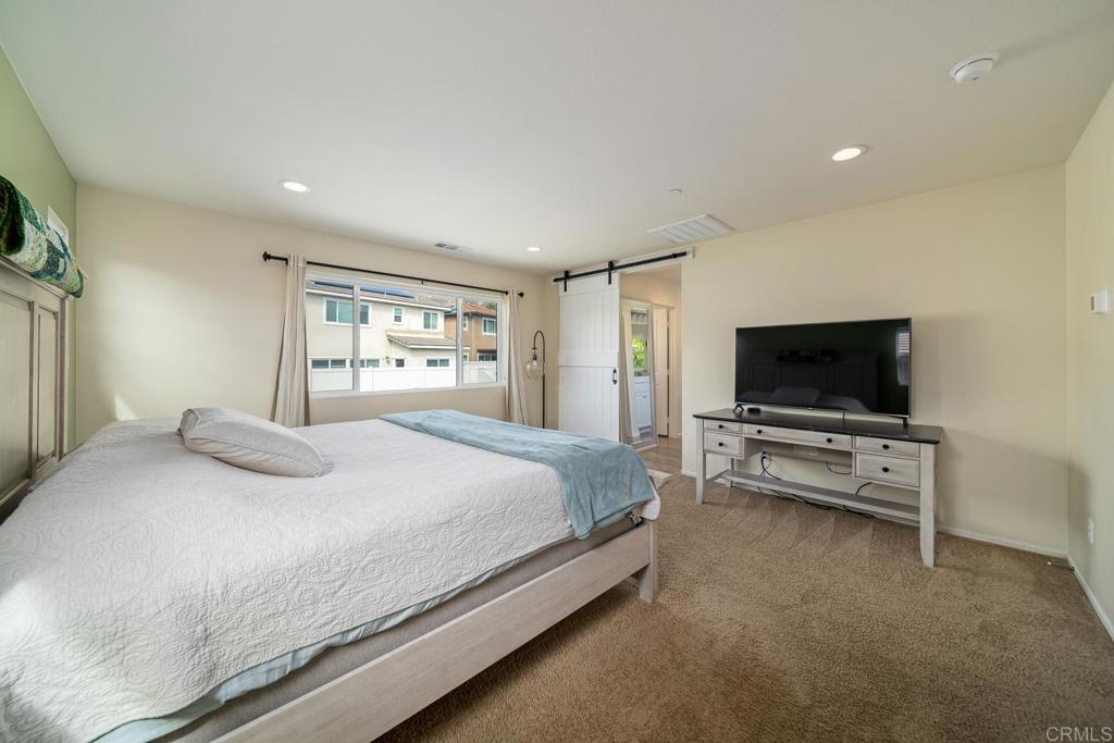 352 Misaki Way Fallbrook, CA 92028 - Photo 39 of 68 a bedroom with a bed and a flat screen tv