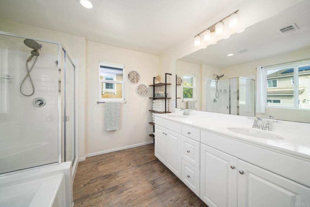 352 Misaki Way Fallbrook, CA 92028 - Photo 43 of 68 a spacious bathroom with a double vanity sink a large mirror a shower and vanity