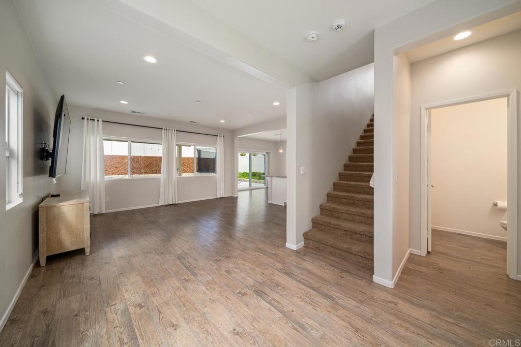352 Misaki Way Fallbrook, CA 92028 - Photo 5 of 68 an empty room with wooden floor and windows
