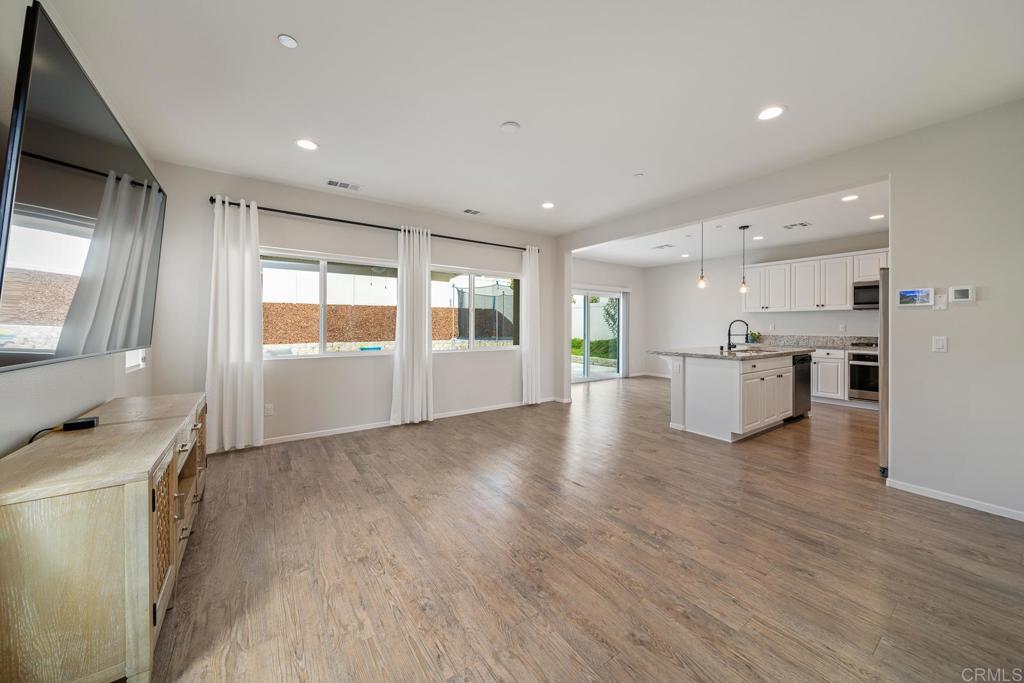 352 Misaki Way Fallbrook, CA 92028 - Photo 7 of 68 a view of a kitchen with a sink wooden floor and a window