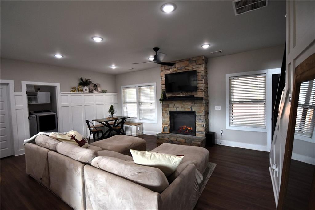 533 Lively Road Waco, GA 30182 - Photo 40 of 41 a living room with furniture a fireplace and a flat screen tv