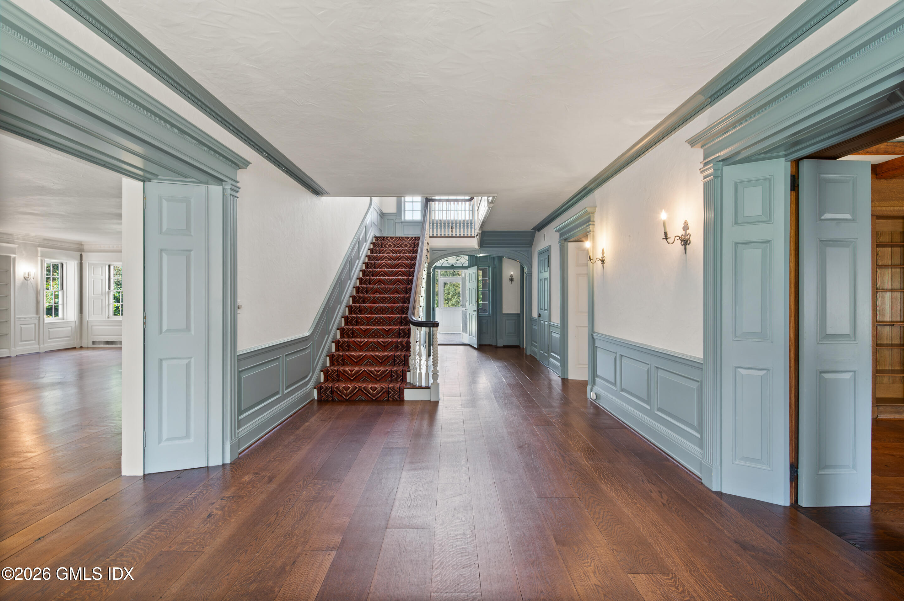 122 Round Hill Road Greenwich, CT 06831 - Photo 3 of 37 a view of a hallway with wooden floor and stairs
