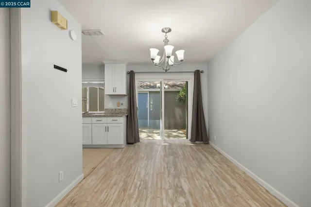 a view of livingroom with kitchen and hardwood