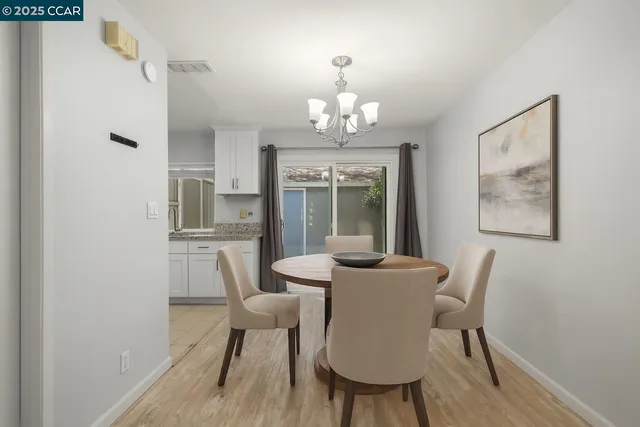 a view of a dining room with furniture wooden floor and chandelier
