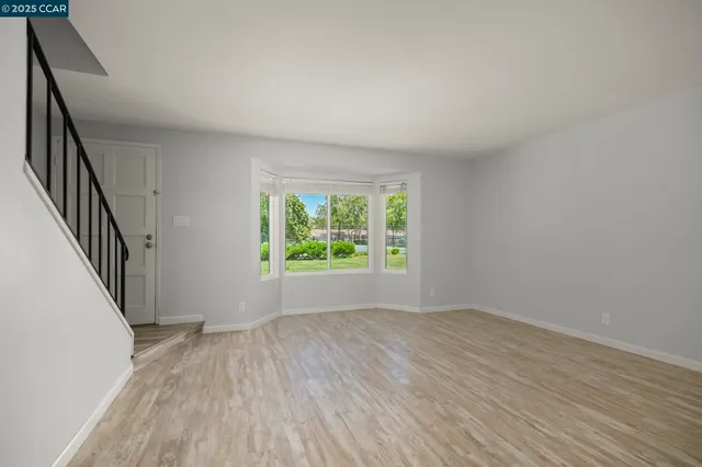 wooden floor in an empty room with a window