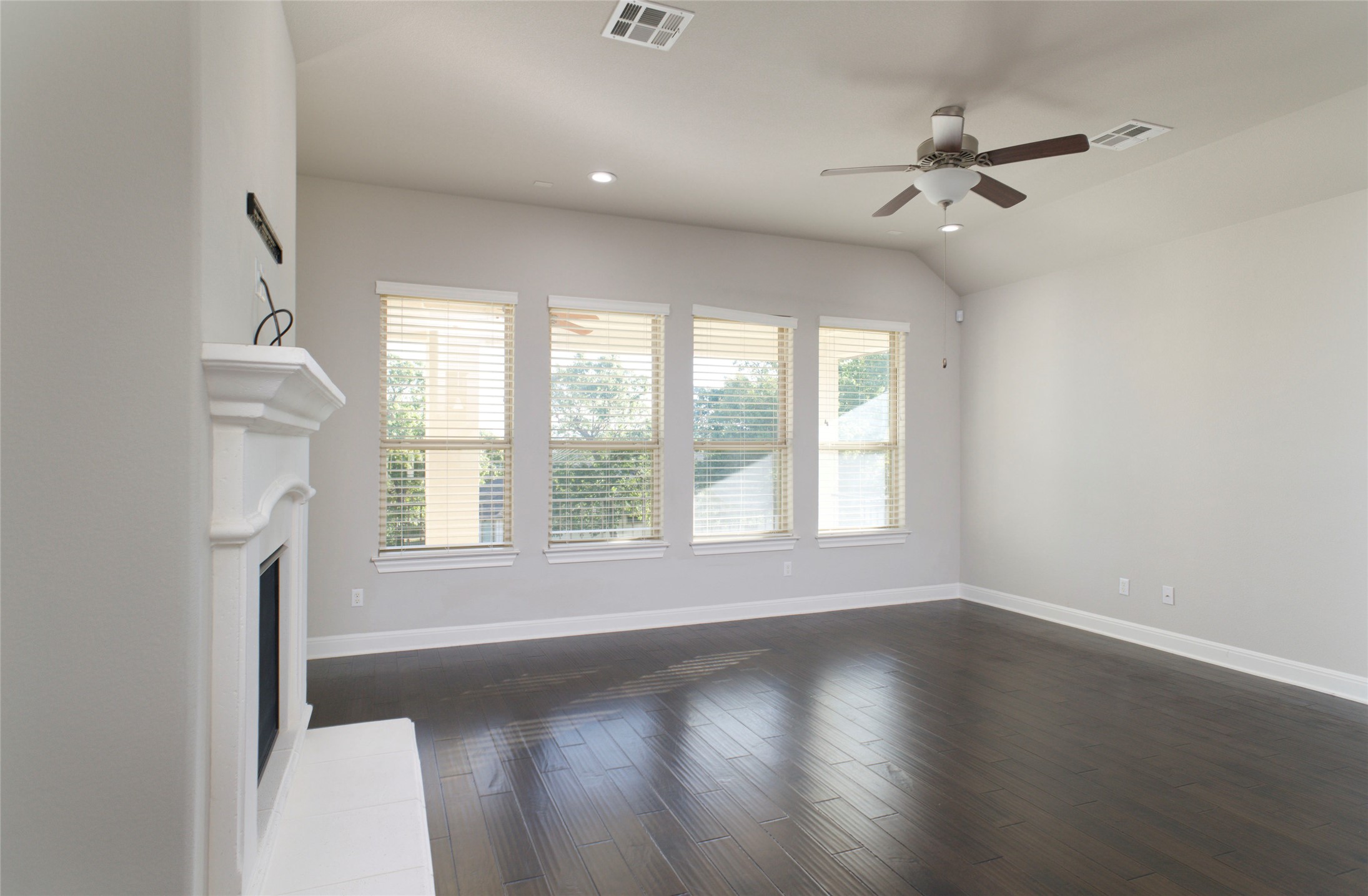 4001 Goodnight Trail Leander, TX 78641 - Photo 13 of 35 an empty room with wooden floor fan and windows