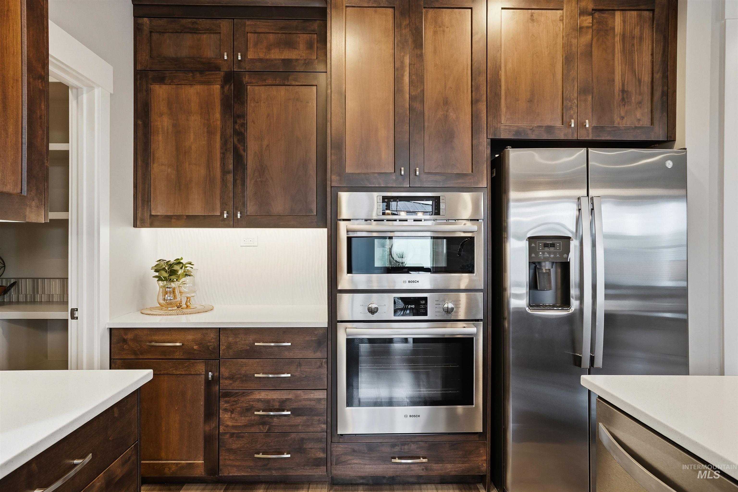 8087 Tandy Cove Street Middleton, ID 83644 - Photo 16 of 50 Kitchen featuring stainless steel appliances and dark wood finish cabinetry