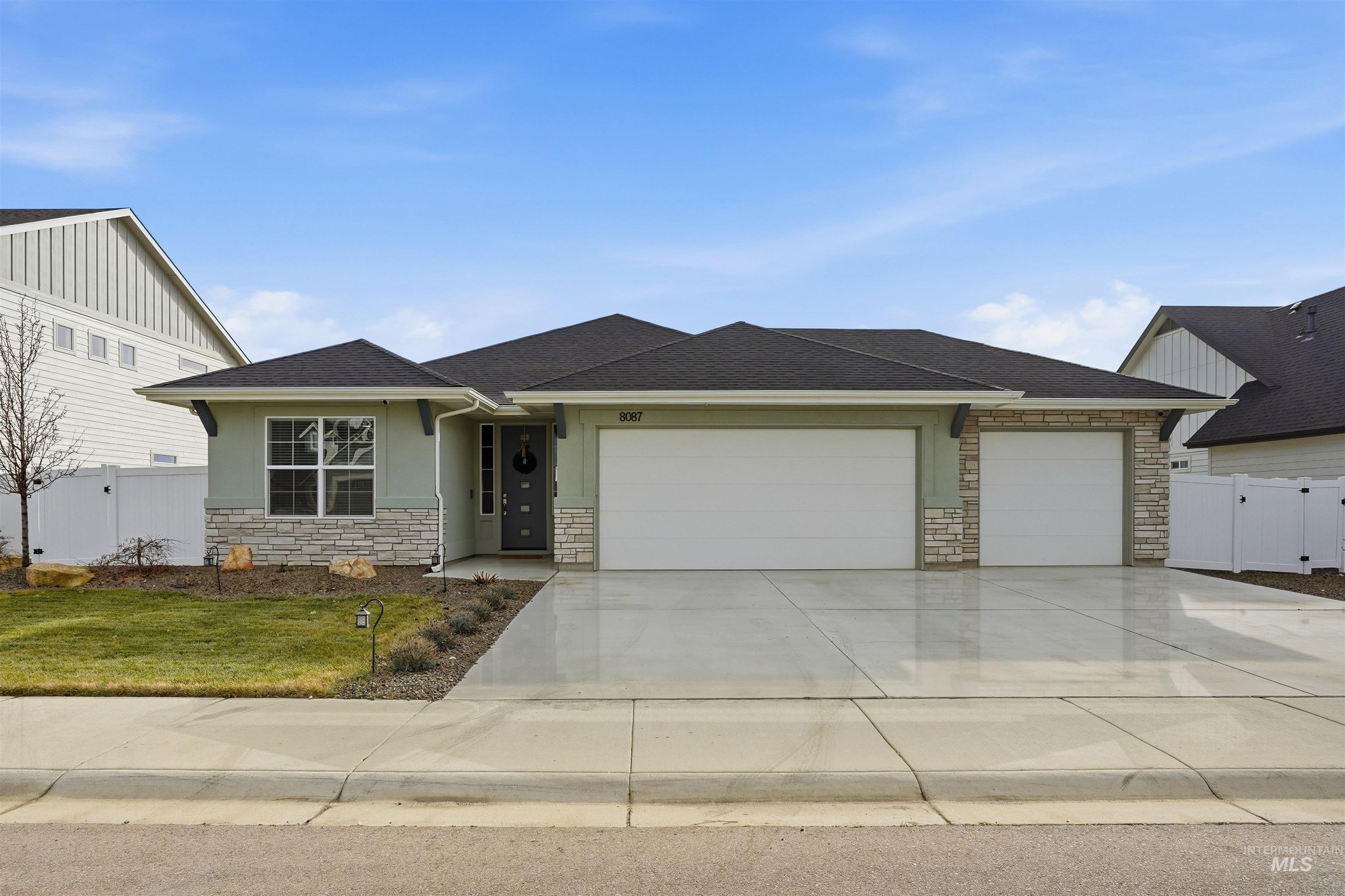 8087 Tandy Cove Street Middleton, ID 83644 - Photo 2 of 50 View of front of house featuring a gate, stone siding, concrete driveway, and an attached garage