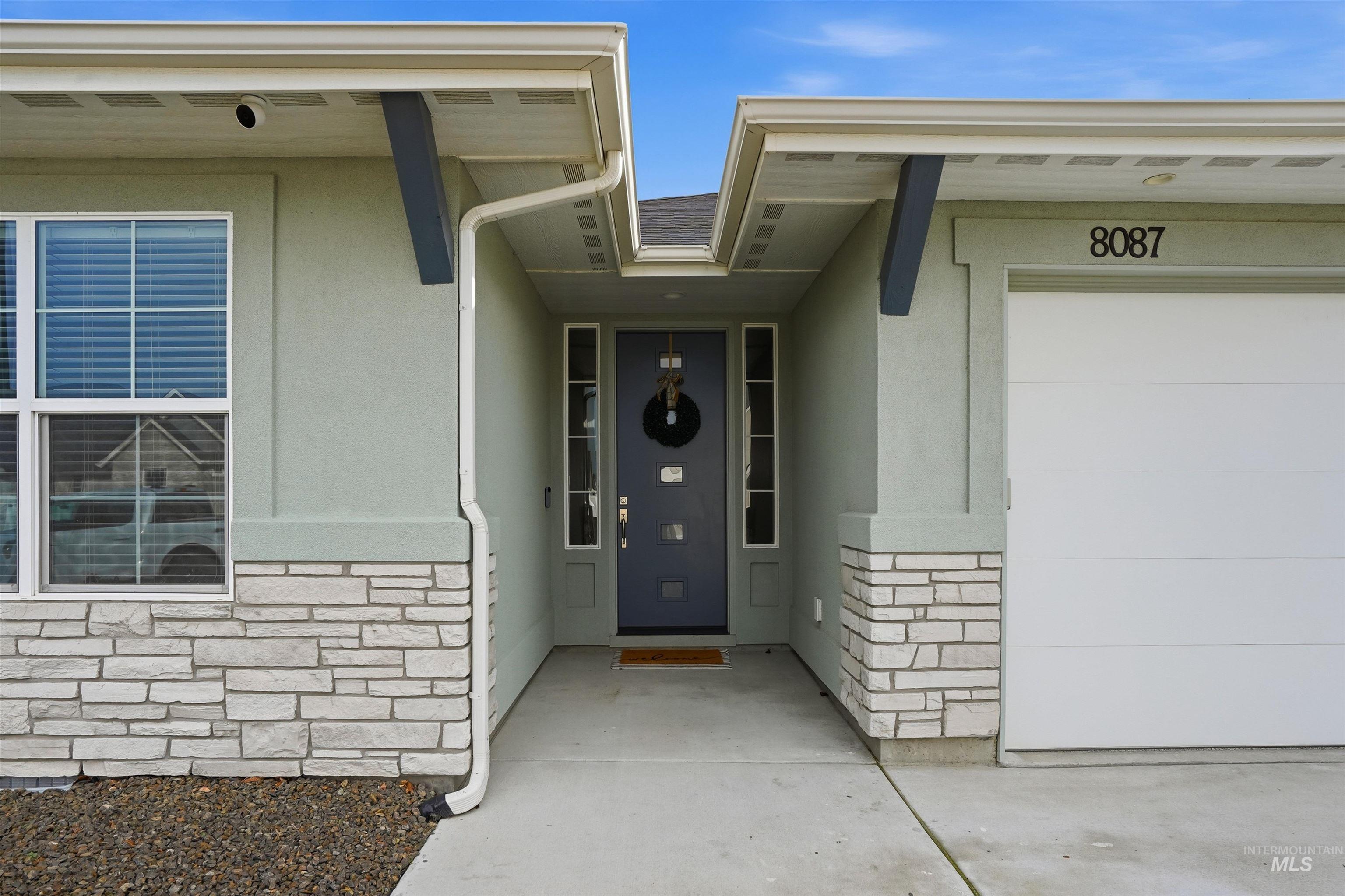 8087 Tandy Cove Street Middleton, ID 83644 - Photo 2 of 50 Doorway to property featuring stone siding, stucco siding, and a porch