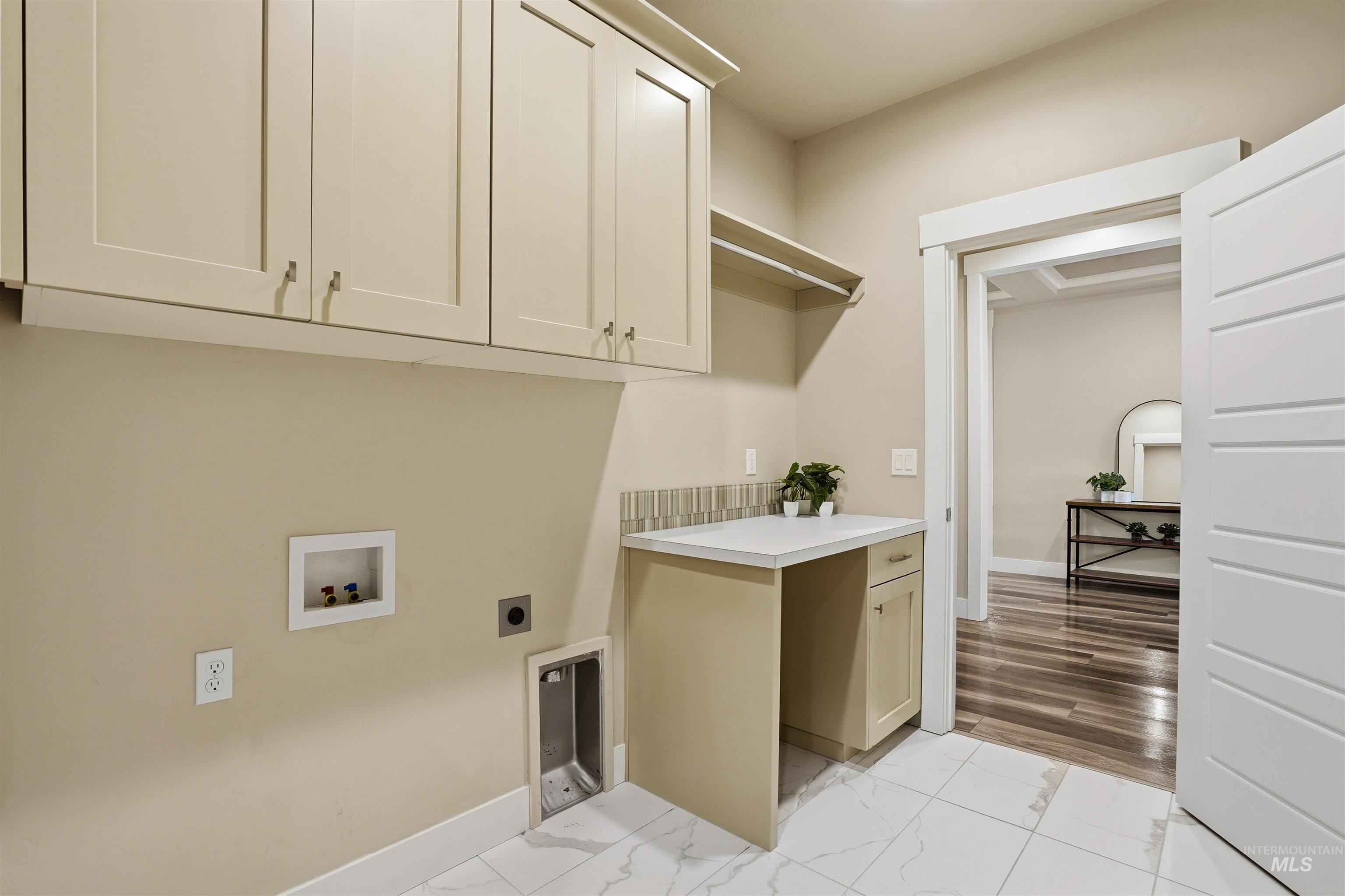 8087 Tandy Cove Street Middleton, ID 83644 - Photo 27 of 50 Laundry area featuring electric dryer hookup, cabinet space, light marble finish flooring, and hookup for a washing machine