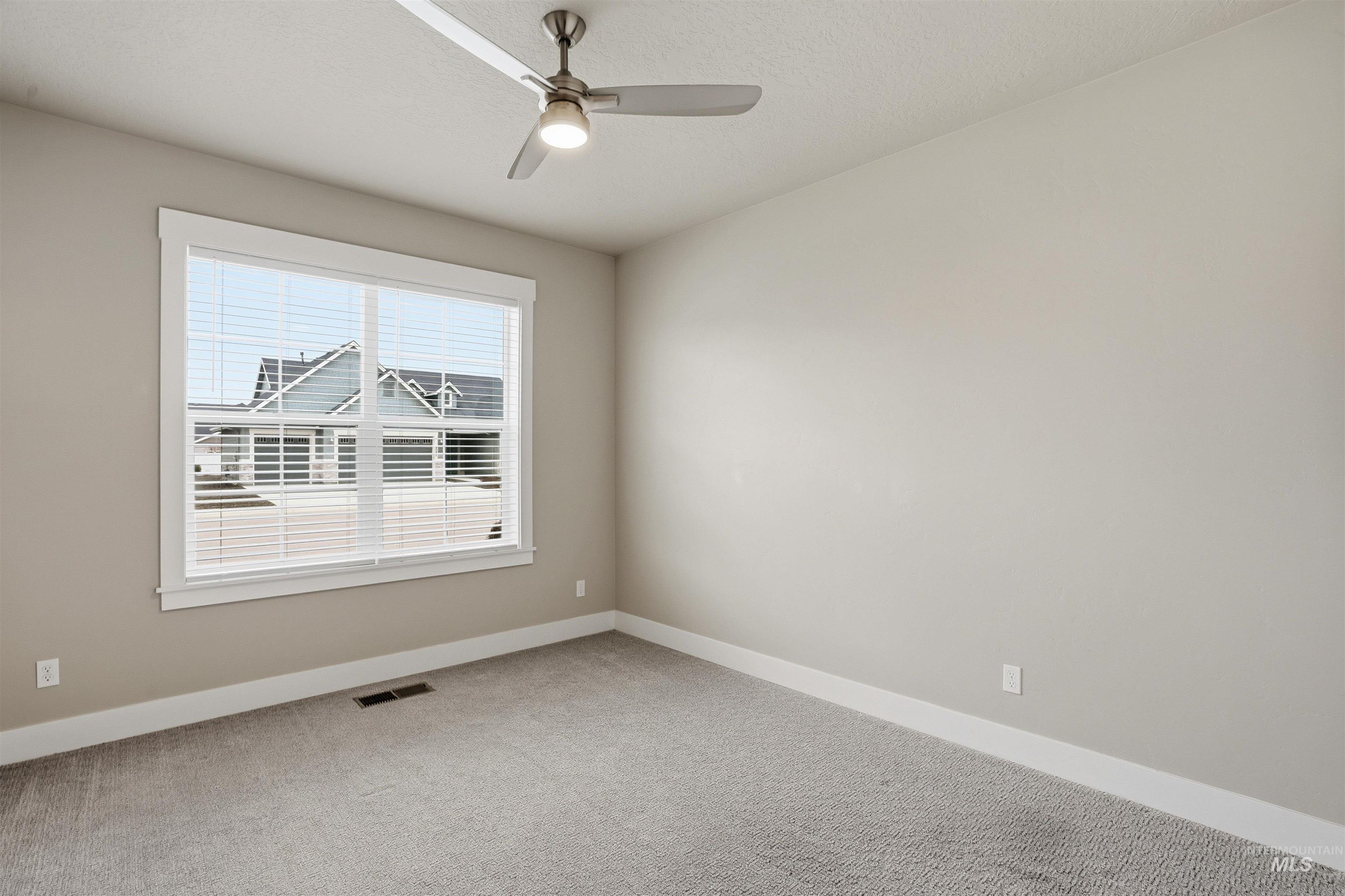 8087 Tandy Cove Street Middleton, ID 83644 - Photo 29 of 50 Unfurnished room with carpet flooring, a ceiling fan, and a textured ceiling