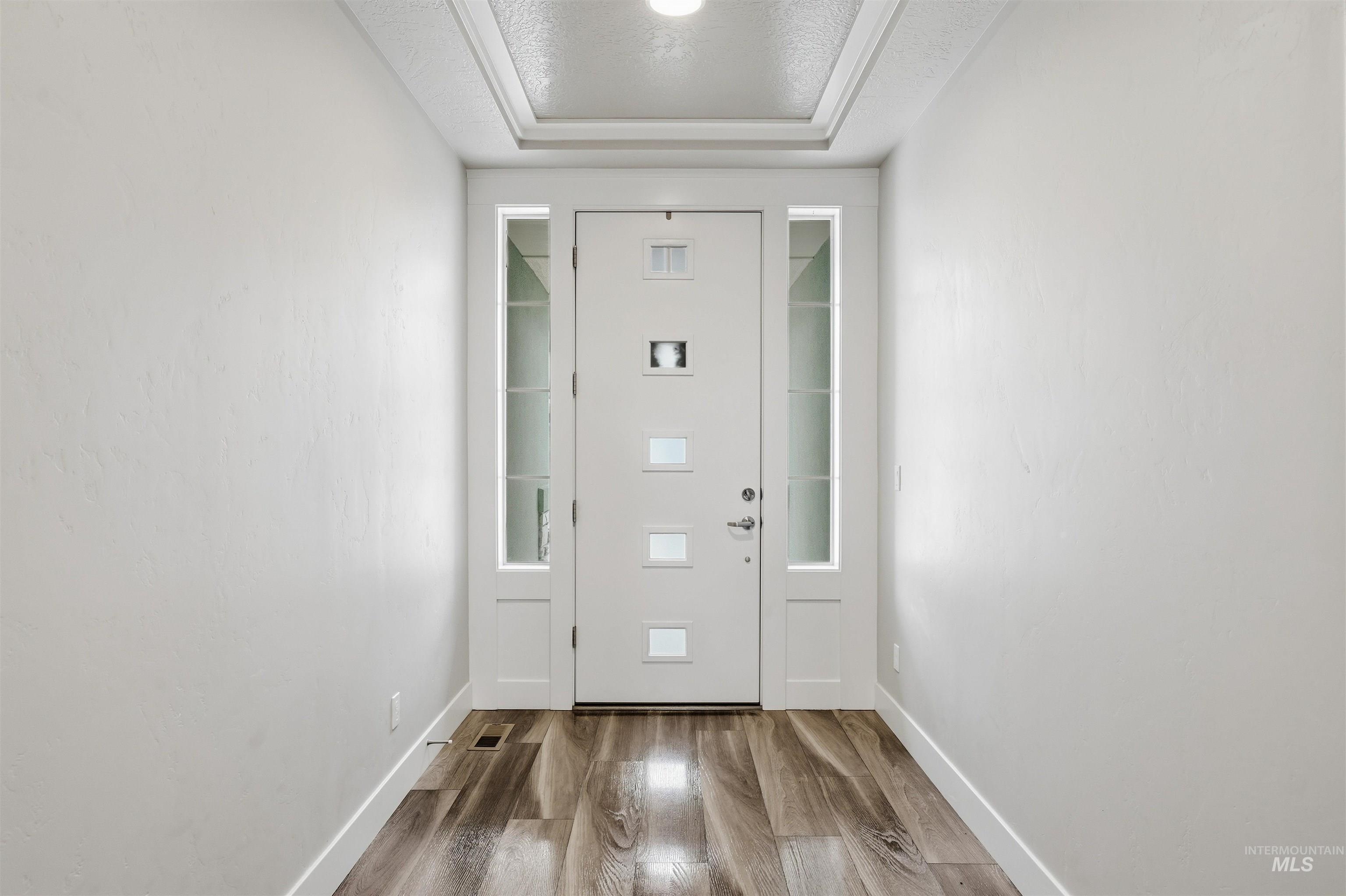 8087 Tandy Cove Street Middleton, ID 83644 - Photo 3 of 50 Entrance foyer featuring wood finished floors and a textured ceiling