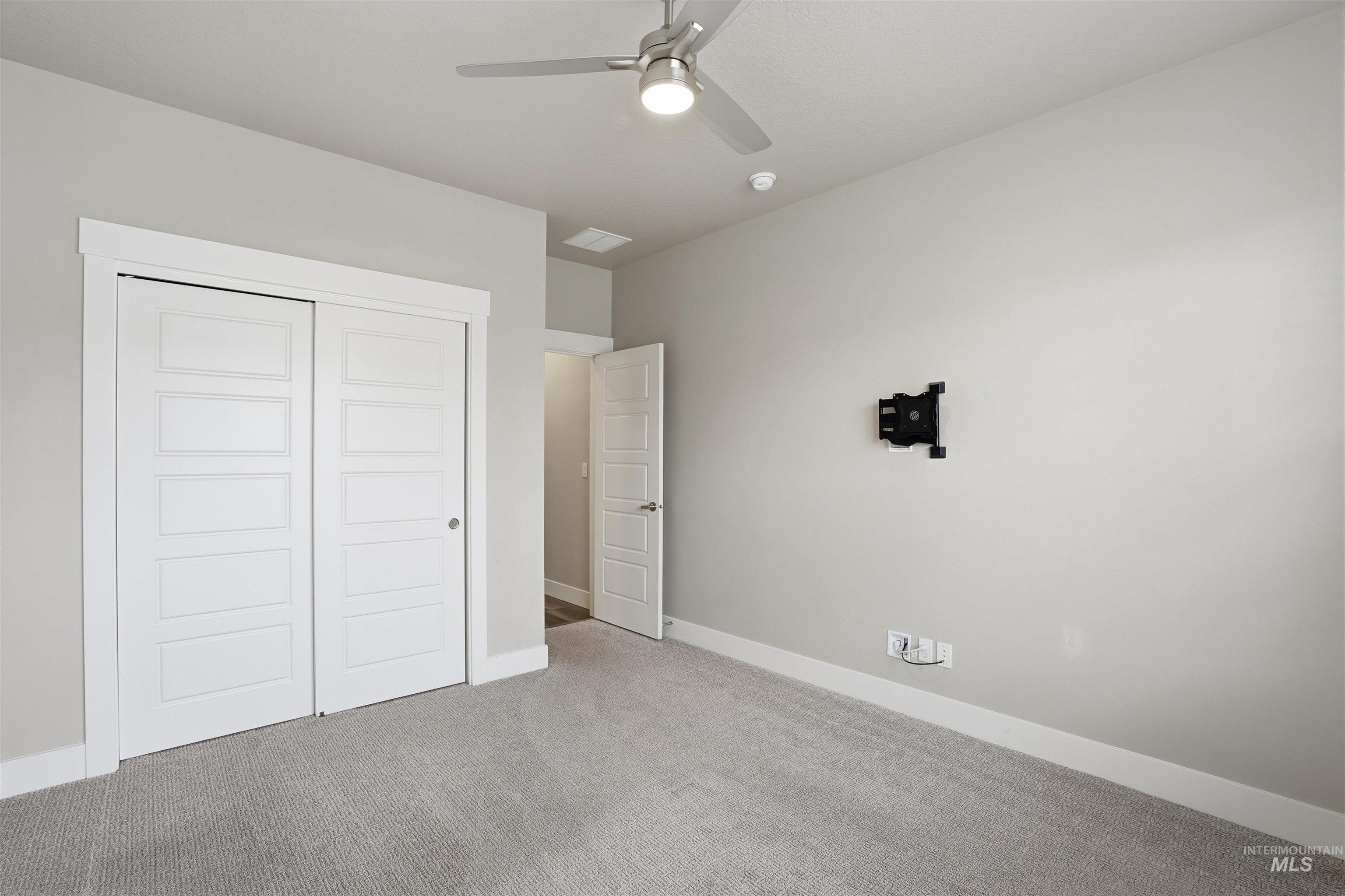 8087 Tandy Cove Street Middleton, ID 83644 - Photo 30 of 50 Unfurnished bedroom with carpet floors, a closet, and a ceiling fan