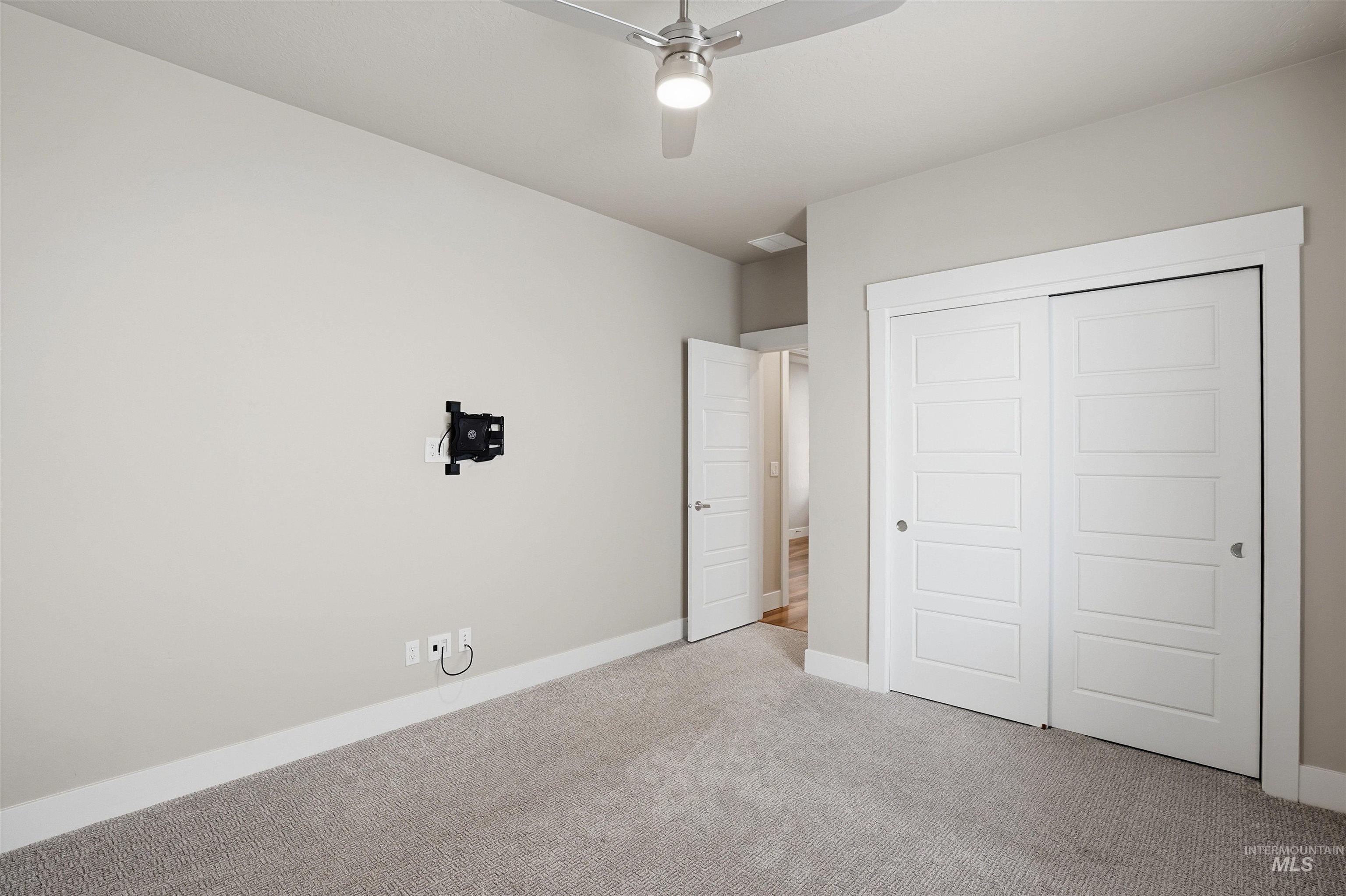 8087 Tandy Cove Street Middleton, ID 83644 - Photo 35 of 50 Unfurnished bedroom with carpet floors, a closet, and a ceiling fan
