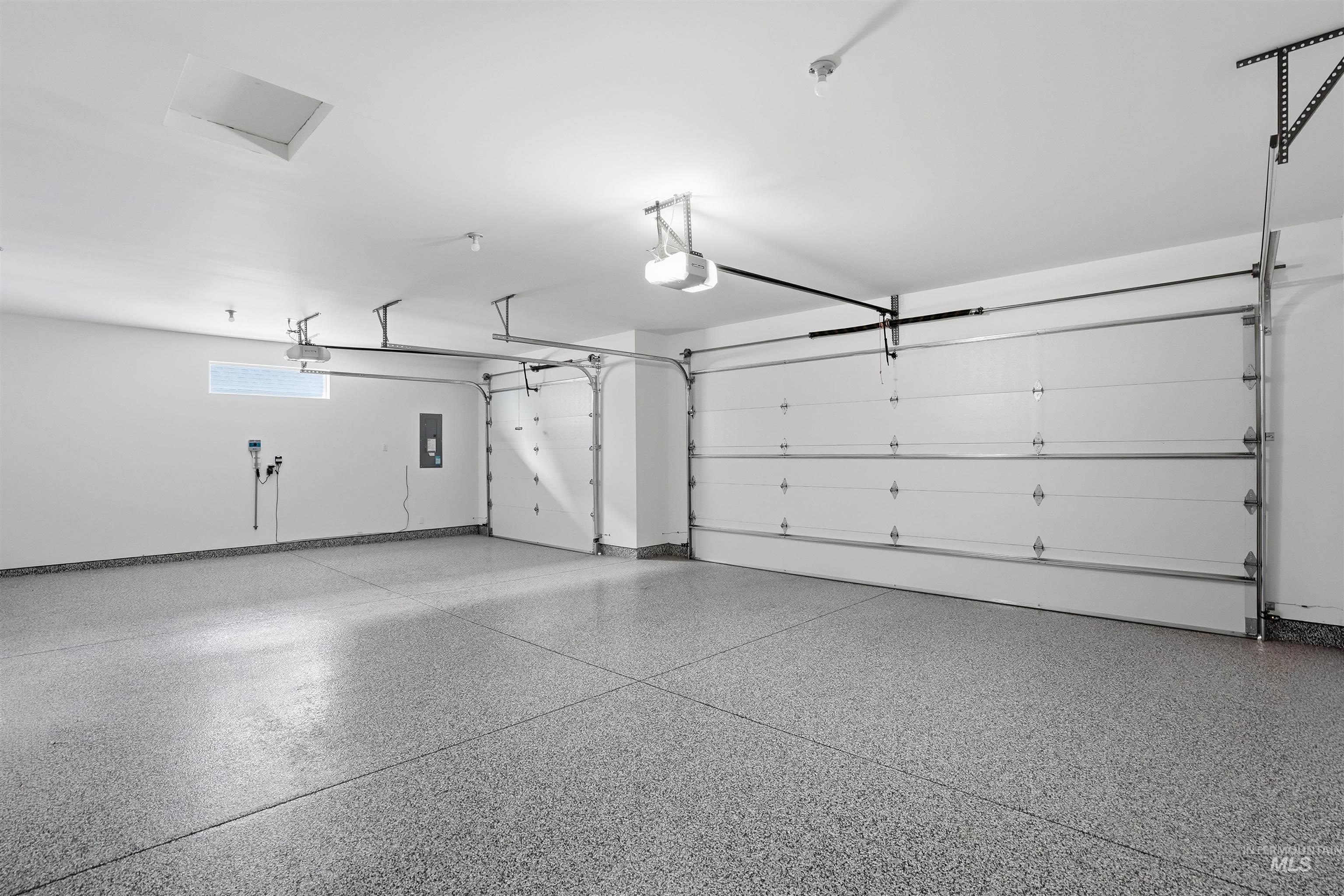 8087 Tandy Cove Street Middleton, ID 83644 - Photo 37 of 50 Garage featuring a garage door opener and baseboards