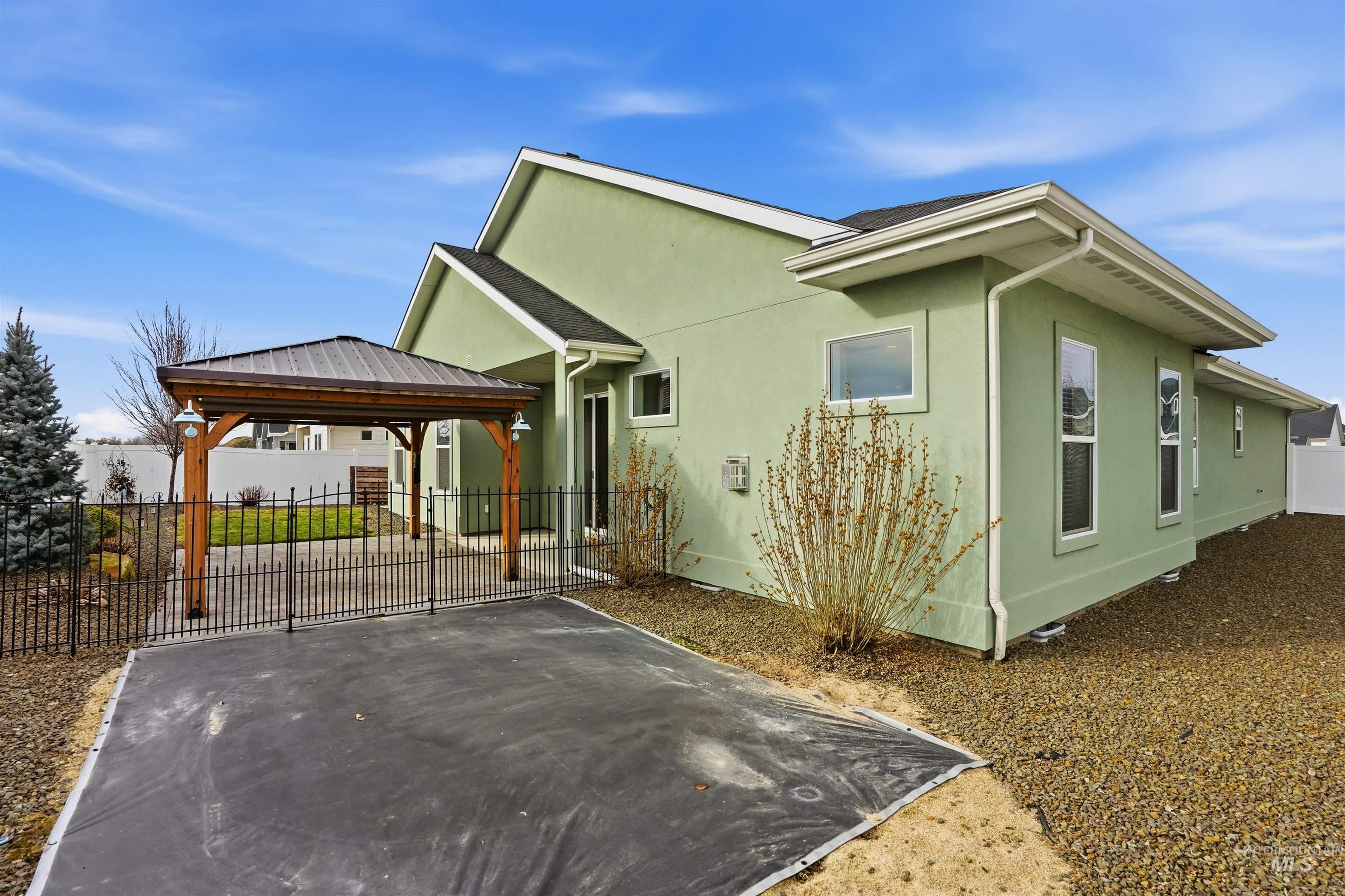 8087 Tandy Cove Street Middleton, ID 83644 - Photo 38 of 50 View of side of property with a patio area, a gazebo, and stucco siding