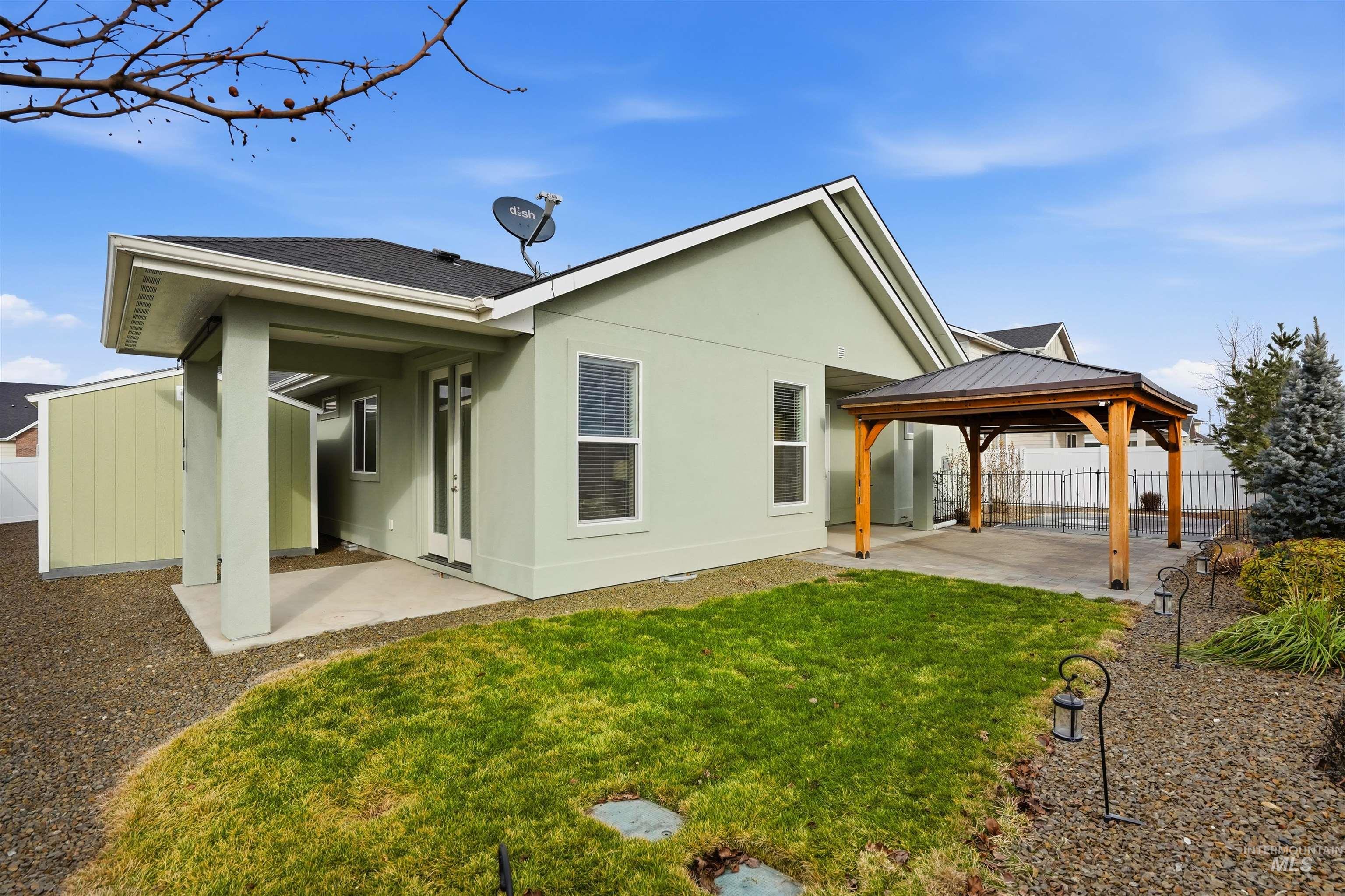 8087 Tandy Cove Street Middleton, ID 83644 - Photo 39 of 50 Rear view of property featuring a patio area, stucco siding, a gazebo, and a fenced backyard