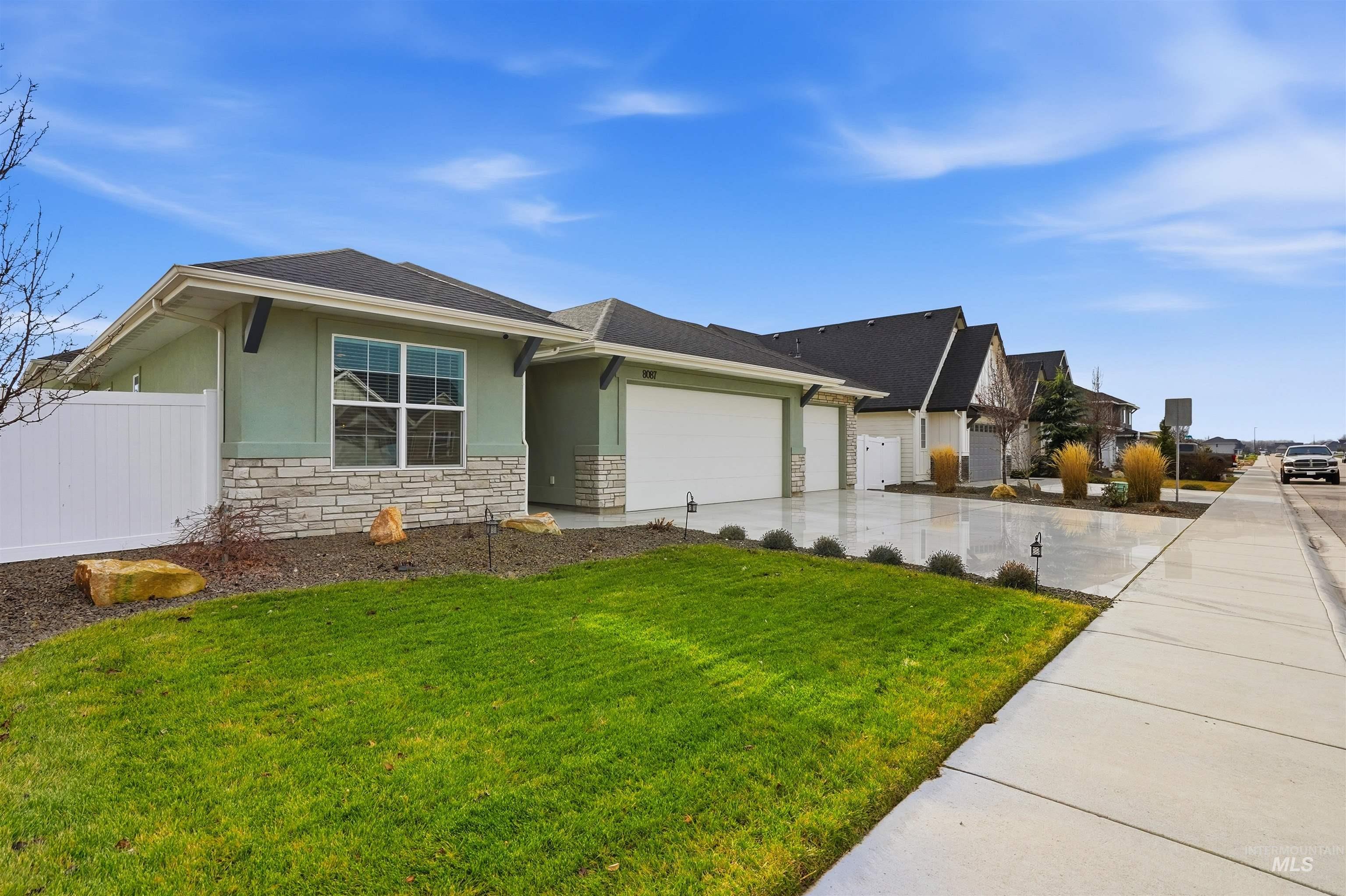 8087 Tandy Cove Street Middleton, ID 83644 - Photo 48 of 50 View of front of house featuring stucco siding, driveway, an attached garage, stone siding, and roof with shingles