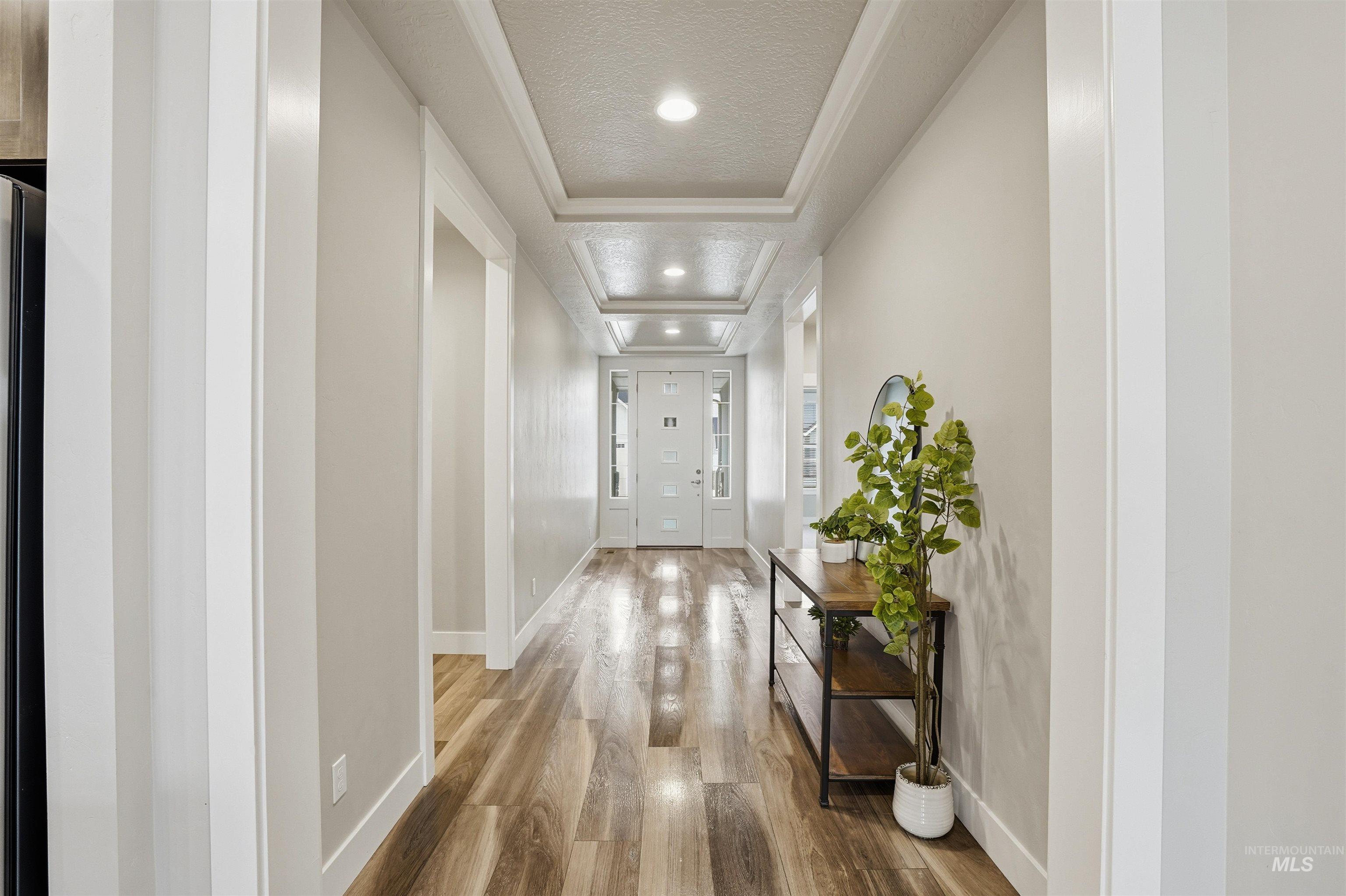 8087 Tandy Cove Street Middleton, ID 83644 - Photo 6 of 50 Corridor with ornamental molding, wood finished floors, recessed lighting, and a textured ceiling