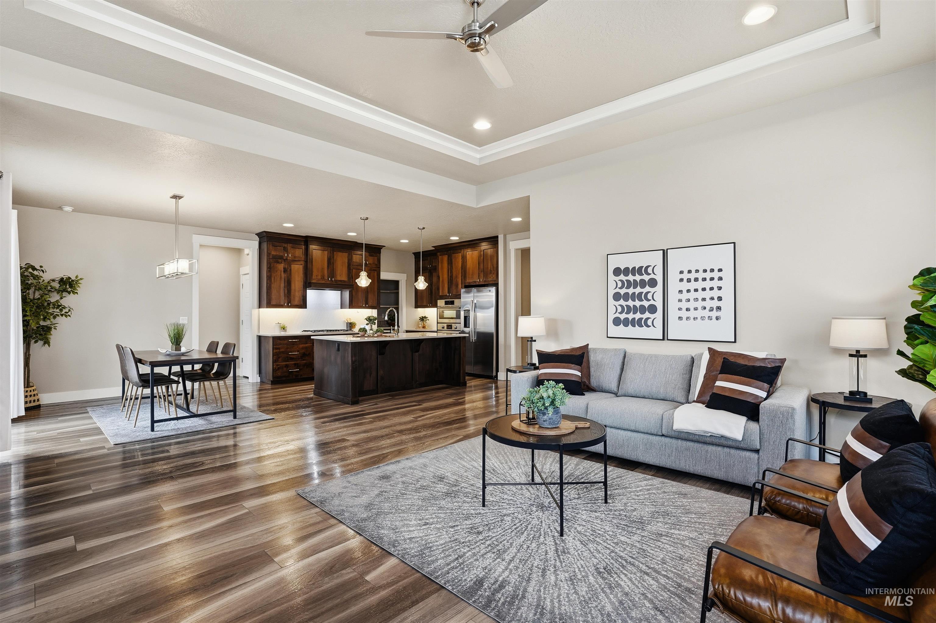 8087 Tandy Cove Street Middleton, ID 83644 - Photo 10 of 50 Living area with a tray ceiling, recessed lighting, dark wood-type flooring, and ceiling fan
