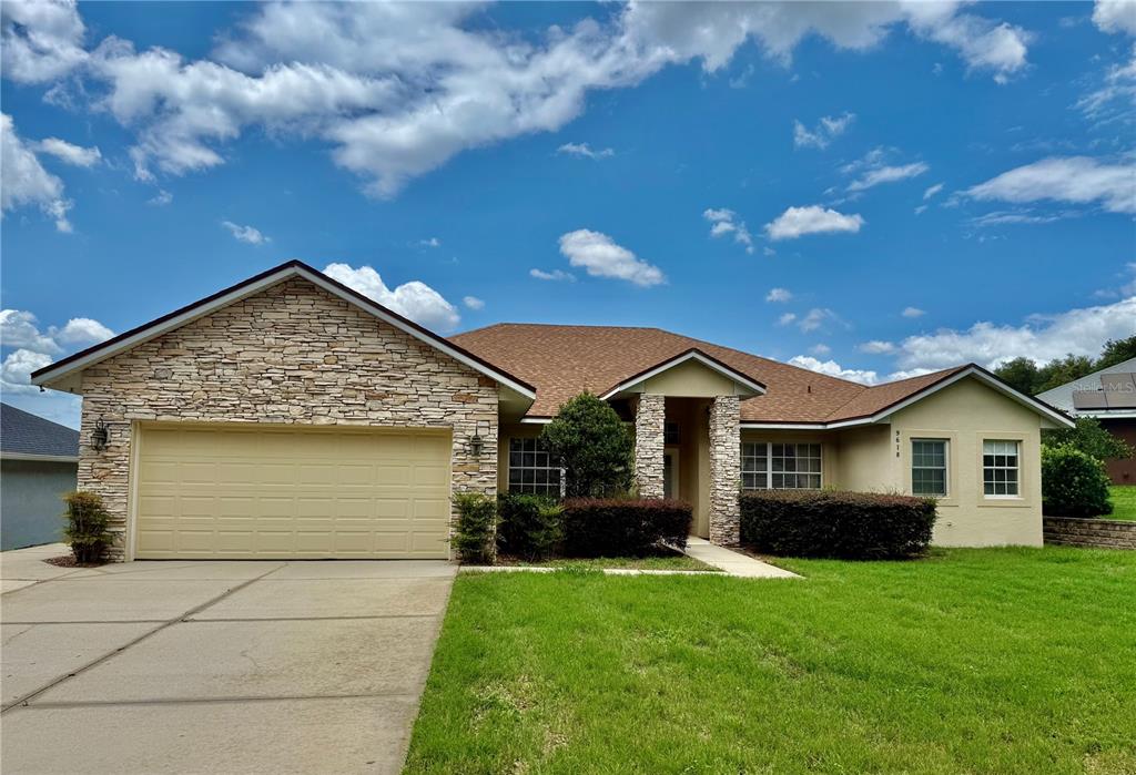 a view of front of house with a yard
