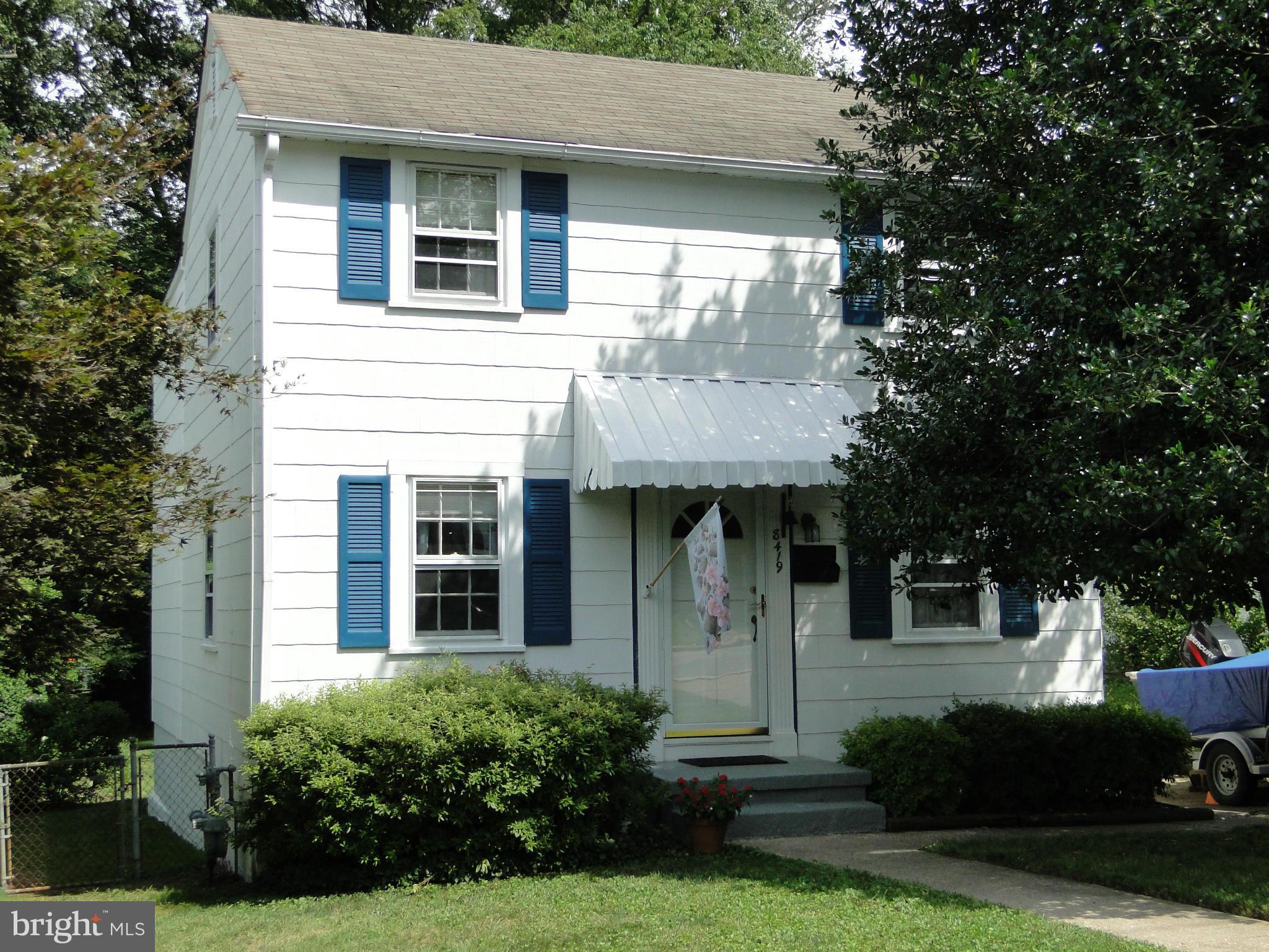 a front view of a house with a yard garage and outdoor seating