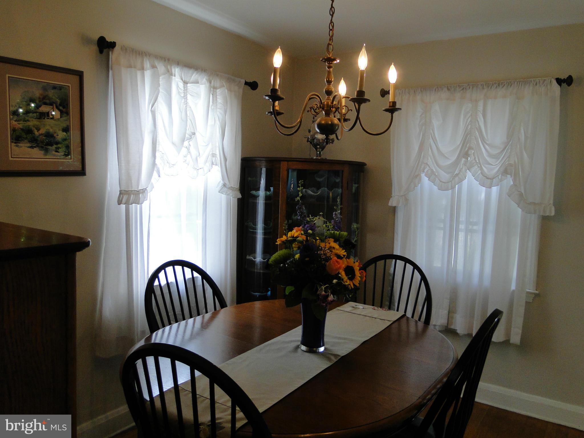 8419 Oakleigh Road Baltimore, MD 21234 - Photo 11 of 30 a view of a dining room with furniture wooden floor and chandelier