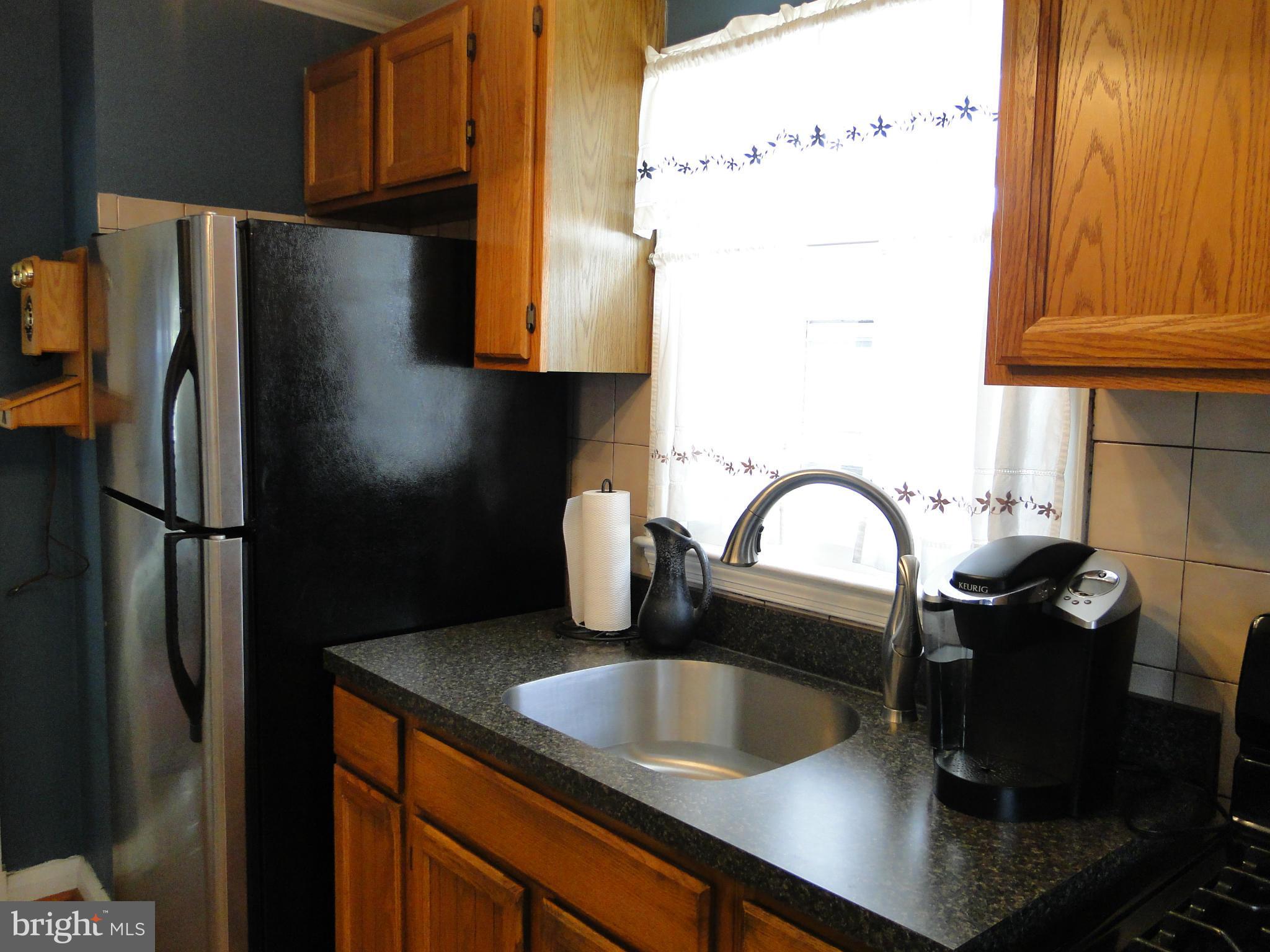 8419 Oakleigh Road Baltimore, MD 21234 - Photo 17 of 30 a kitchen with a refrigerator and a sink