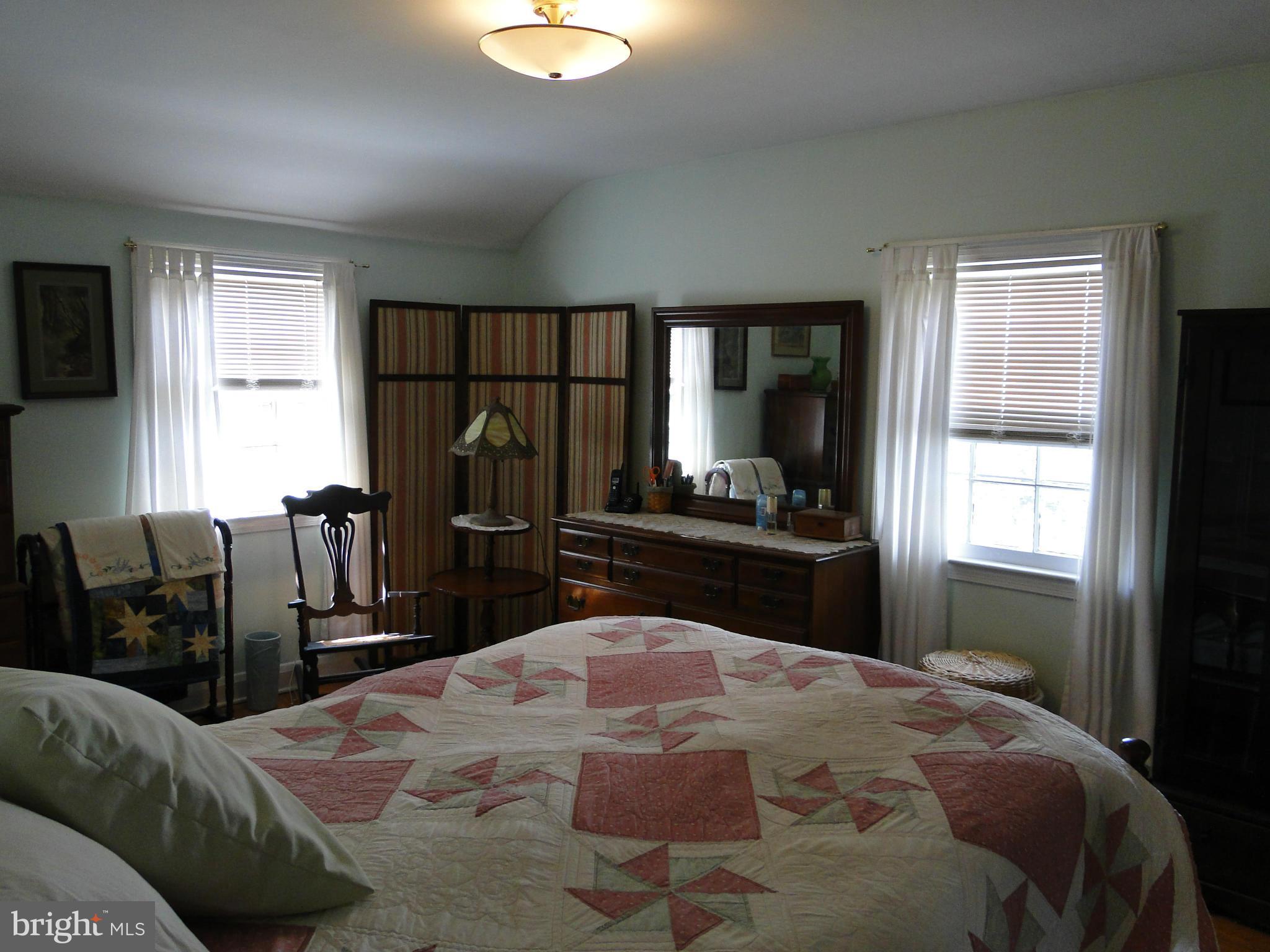 8419 Oakleigh Road Baltimore, MD 21234 - Photo 20 of 30 a bedroom with a bed window and couch