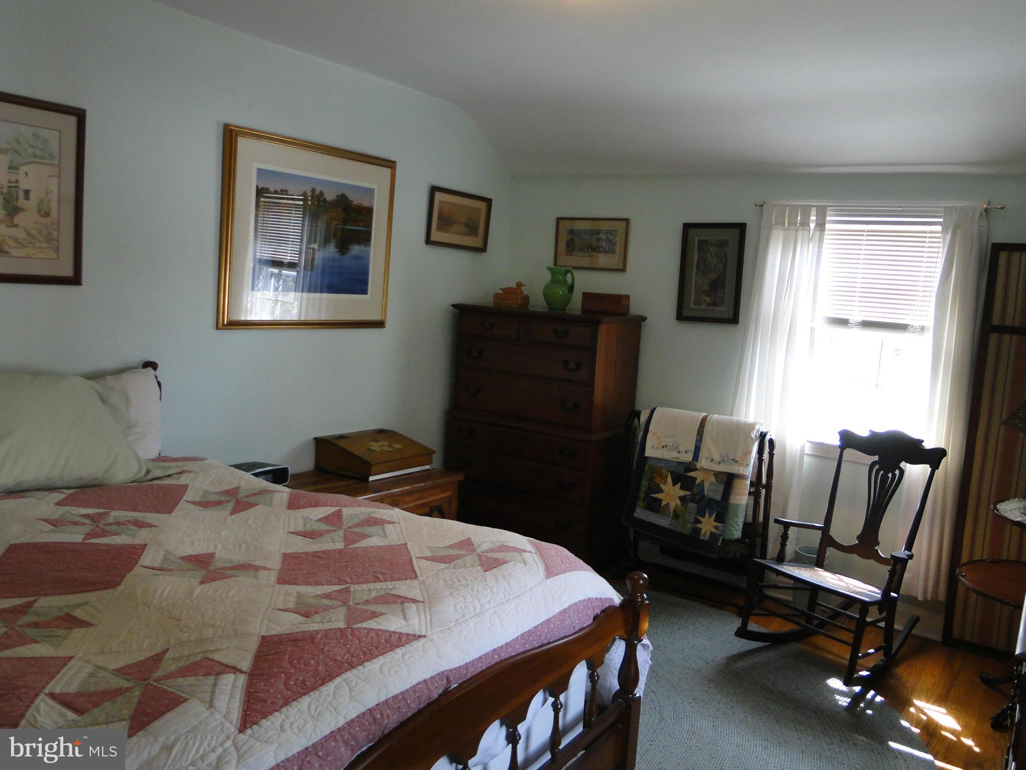 8419 Oakleigh Road Baltimore, MD 21234 - Photo 21 of 30 a bedroom with a bed and a table in it