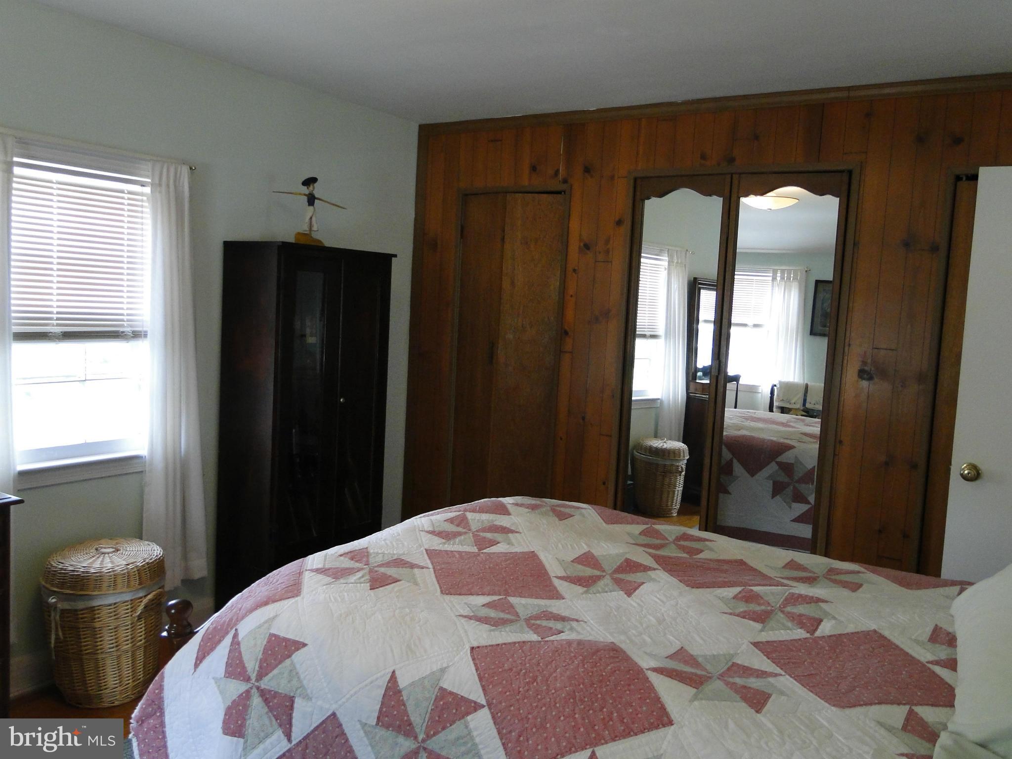 8419 Oakleigh Road Baltimore, MD 21234 - Photo 22 of 30 a bedroom with a bed and wooden floor