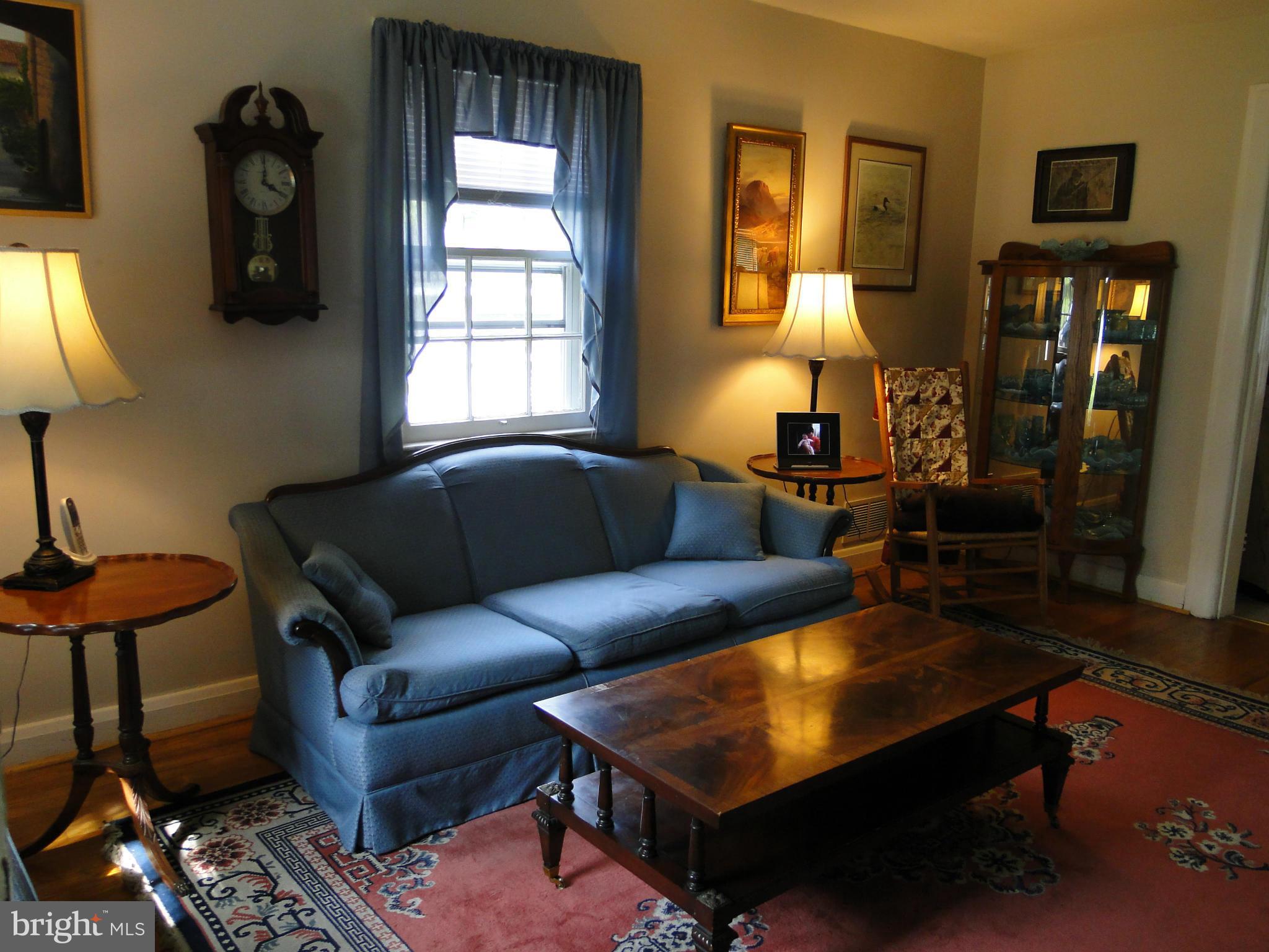 8419 Oakleigh Road Baltimore, MD 21234 - Photo 7 of 30 a living room with furniture and a lamp