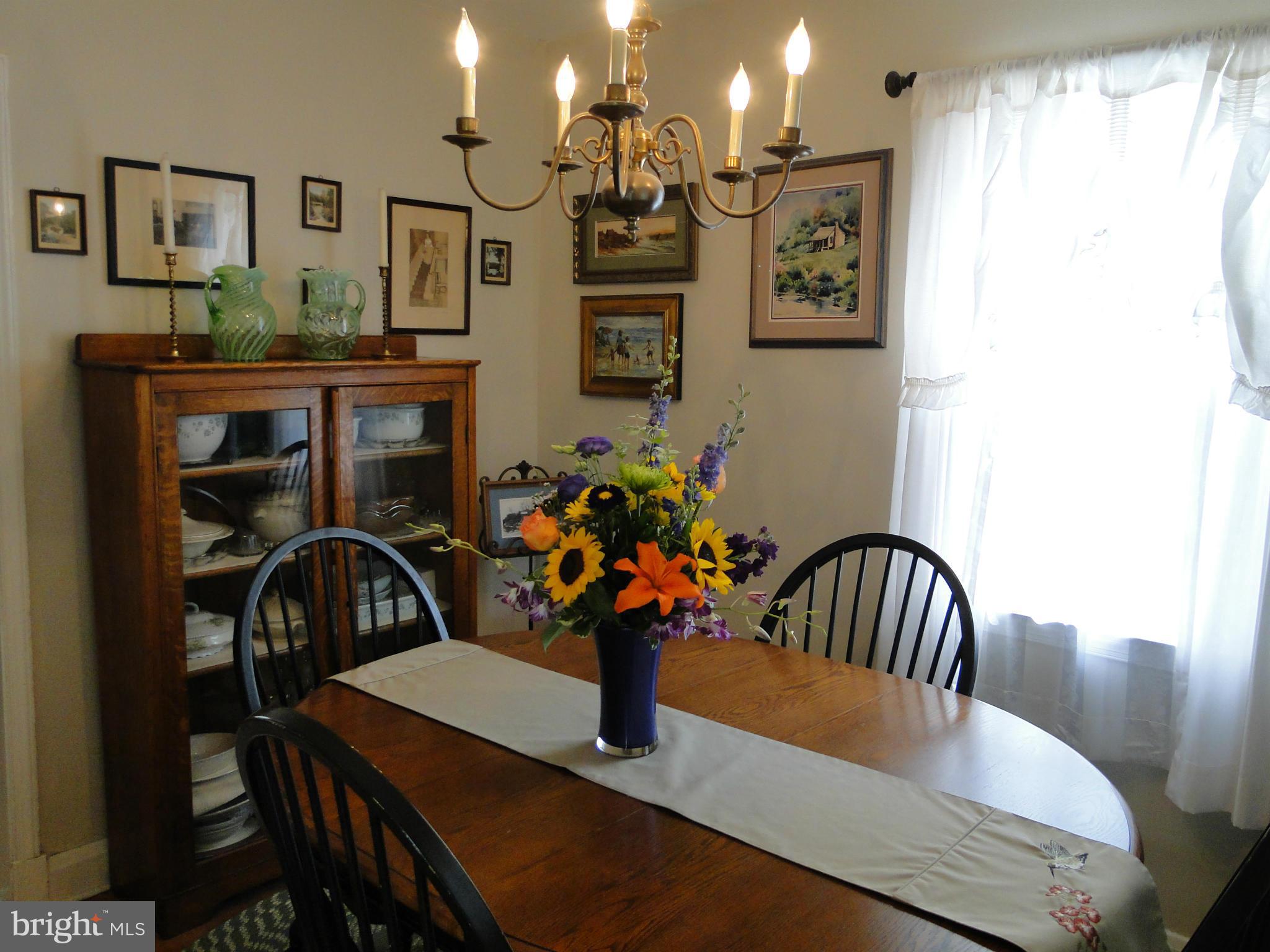 8419 Oakleigh Road Baltimore, MD 21234 - Photo 10 of 30 a view of a dining room with furniture and chandelier