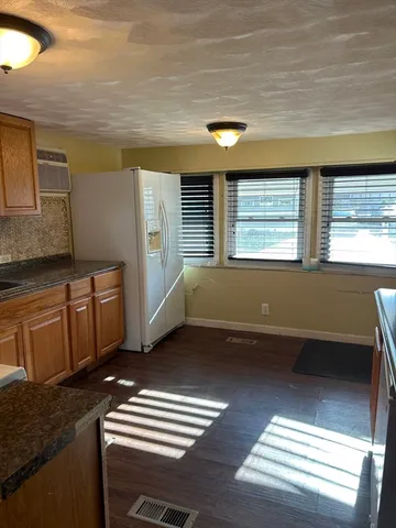 a view of kitchen and hall with wooden floor