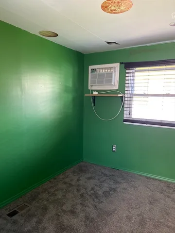 a view of a room with window and fan
