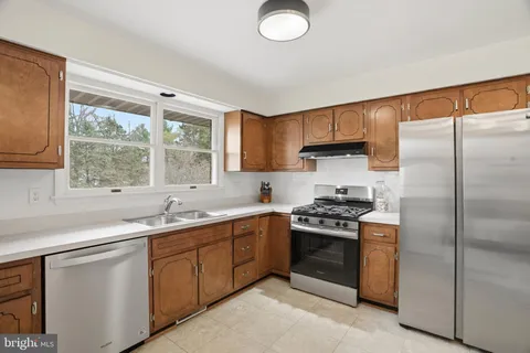 a kitchen with a sink stove and refrigerator