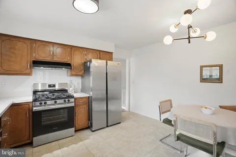 a kitchen with stainless steel appliances a stove a refrigerator and a sink