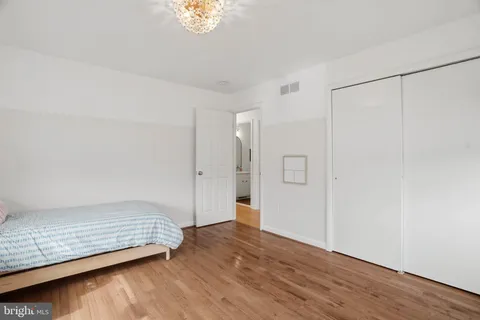 a view of room with hardwood floor and hallway