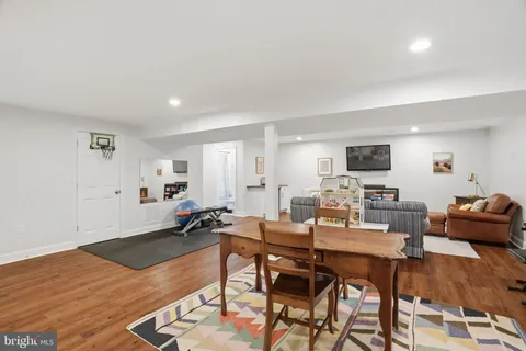 a living room with furniture a rug and a table